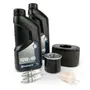 Top view of Husqvarna engine maintenance kit including oil bottles, spark plugs, filters, and air filter.