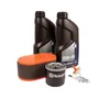 Top view of Husqvarna engine maintenance kit including oil bottles, air filter, oil filter, and spark plug.