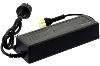Side view of a Husqvarna Group power supply unit with attached cables.