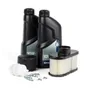 Front view of Husqvarna engine maintenance kit including oil bottles, spark plugs, and filters.