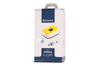 Front view of a Husqvarna chainsaw care kit box, showing filter and spark plug images.