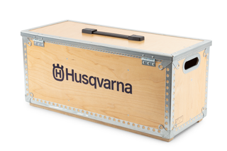 Wooden storage box with Husqvarna branding and a handle on top.