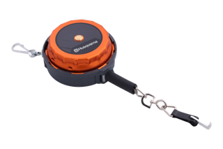 Studio view of a Husqvarna forestry measuring tape reel with chain, carabiner and hook.