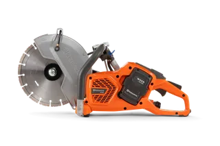 Side view of a Husqvarna power cutter with visible blade and battery compartment.
