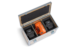 Top view of a Husqvarna battery storage case containing two batteries and a charger.