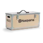 Wooden Husqvarna storage box with metal reinforcements and a handle, labeled 'PACE'.