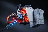 Close-up of a power cutter cutting through a large stone block, showcasing its internal mechanics.