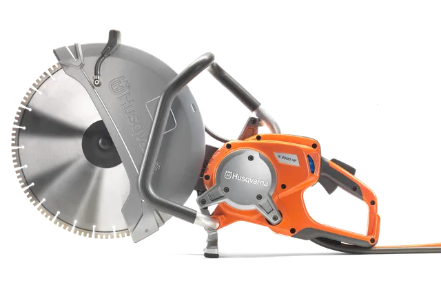 Side view of a Husqvarna power cutter with ergonomic handle and large cutting blade.