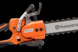 Side view of a Husqvarna chainsaw with ergonomic handle and visible branding.