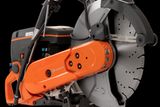 Side view of a Husqvarna power cutter with a visible cutting blade.