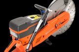 Side view of a Husqvarna power cutter with ergonomic handle and visible blade.