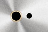 Close-up view of a metal surface with two circular cutouts.