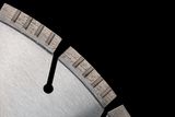 Close-up of a construction saw blade with segmented edge.