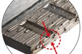 Close-up of a metal surface with red arrows highlighting specific features.
