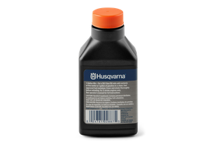 Front view of a Husqvarna oil mix bottle with instructions for gasoline mixing.