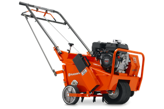 Side view of a Husqvarna lawn aerator with visible engine and controls.