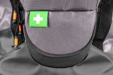 Close-up of a backpack with a green first aid symbol patch.