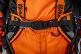 Close-up of a person wearing Husqvarna work gear with a focus on the belt and harness.