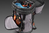 Top view of an open backpack filled with climbing gear, including ropes and carabiners.