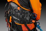 Close-up of a person wearing a Husqvarna climbing harness with various attachment points.