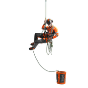A person in work gear suspended in mid-air, holding onto a rope with a rope bag nearby.