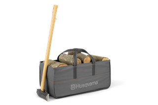 A Husqvarna-branded log carrier filled with cut logs, accompanied by an axe.