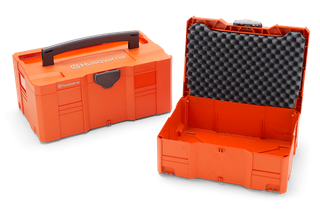 Two Husqvarna toolboxes, one open showing foam padding, and one closed with a handle.