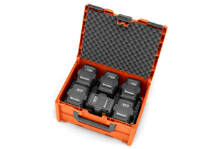 Top view of an open orange storage box containing eight Husqvarna batteries.
