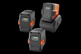 Three Husqvarna batteries of varying capacities and a charger on a white background.