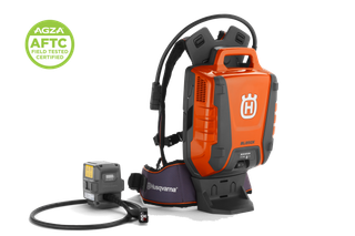 Studio view of Husqvarna backpack battery with cable and adapter, AGZA AFTC certified badge.