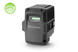 Front view of a Husqvarna battery pack with LED charge indicator, studio shot.