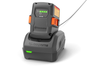 Front view of a Husqvarna battery charger with LED indicators.