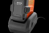 Front view of a Husqvarna battery charger with a battery inserted.