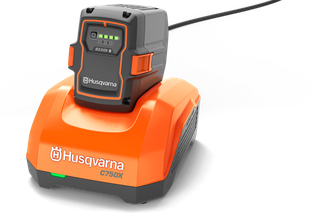 Front view of a Husqvarna C750X battery charger with battery attached.