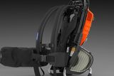 Side view of a backpack leaf blower with ergonomic straps and a protective cover.