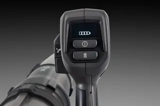 Close-up of a control handle with a digital display showing battery level.