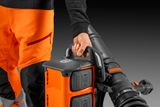Operator carrying a Husqvarna backpack blower.