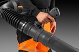 A person holding a leaf blower, showcasing the handle.