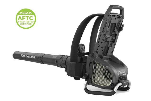 Front angled studio view of a Husqvarna backpack leaf blower with AGZA AFTC certification badge