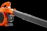 Side view of a Husqvarna leaf blower with a visible air intake and nozzle.
