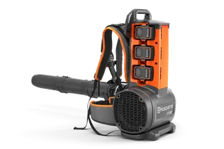 Front-side studio view of a Husqvarna backpack leaf blower with three batteries and harness.