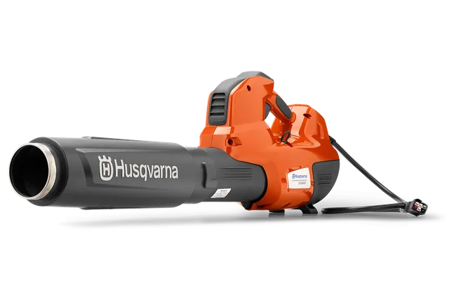 Side view of a Husqvarna leaf blower with a visible power cord.