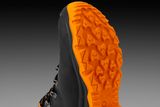 Close-up view of a work boot with a rugged sole, showcasing its tread pattern.