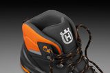 Close-up view of a hiking boot with detailed lacing and rugged design.