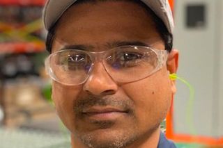 Person wearing work gear in an industrial setting.
