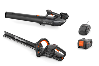 Front view of a Husqvarna leaf blower, hedge trimmer, battery, and charger.