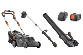 A set of Husqvarna gardening tools including a lawn mower, leaf blower, trimmer, battery, and charger.