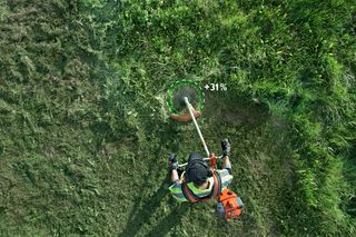 Top view of a person using a grass trimmer on a lawn, with a +31% efficiency overlay.
