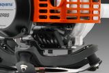 Close-up view of a Husqvarna engine component with visible metal and plastic parts.