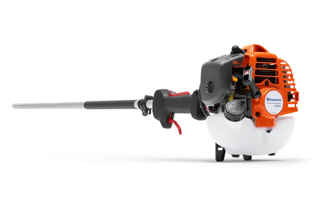 Vista lateral de uma roçadora Husqvarna com motor e pega visíveis.